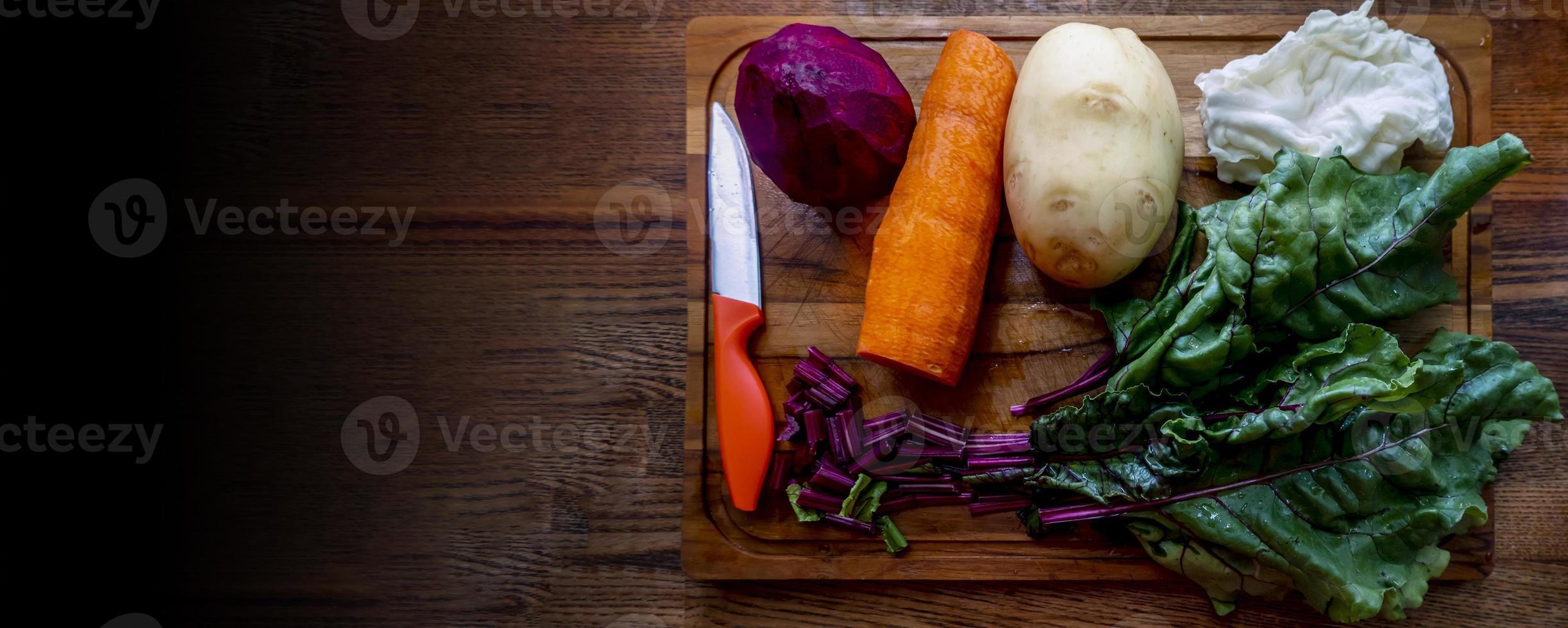 Board with ingredients for preparing tasty borscht on white background photo