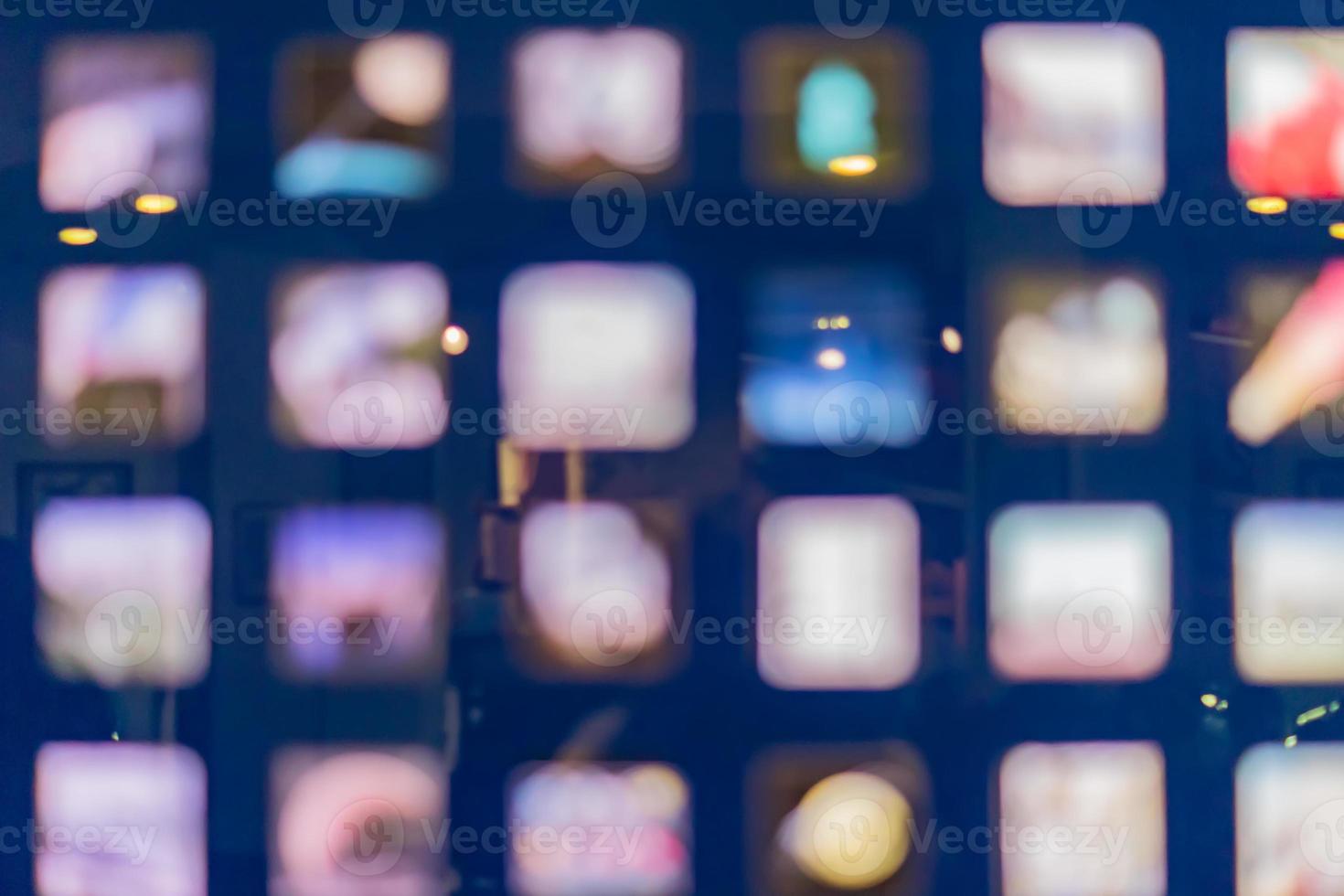 Defocused abstract multicolored bokeh lights background. Square windows at night photo