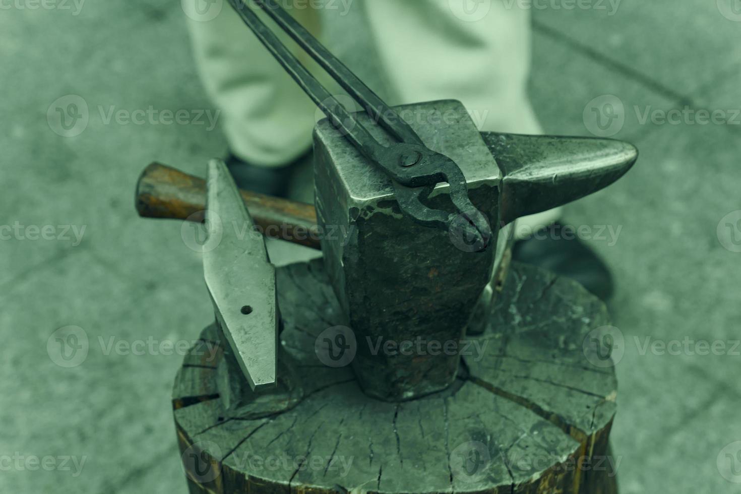 Working metal tools in blacksmith's workshop, close-up, selective focus, toned photo