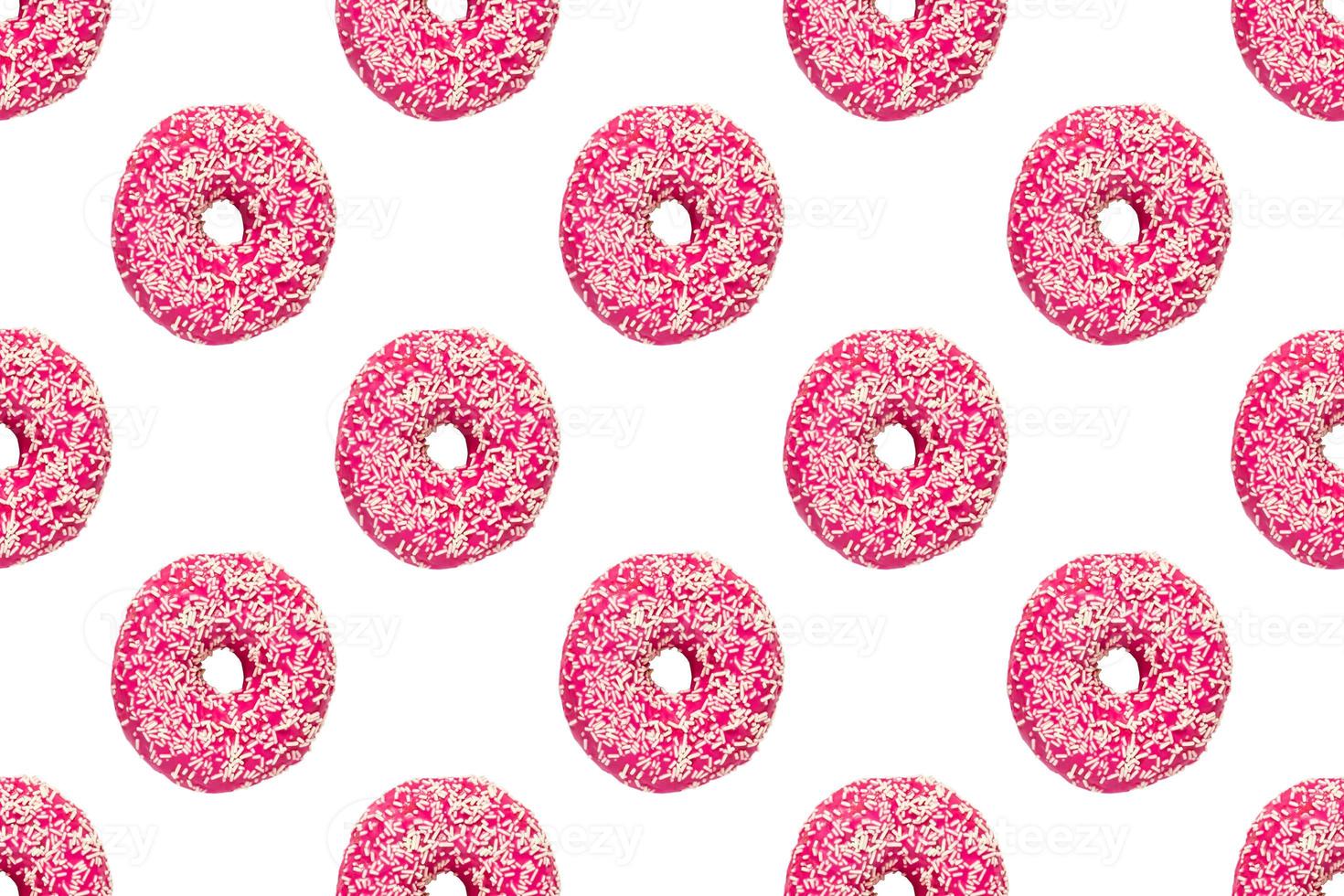 pink frosted donuts with white sprinkles on white background. Seamless pattern photo