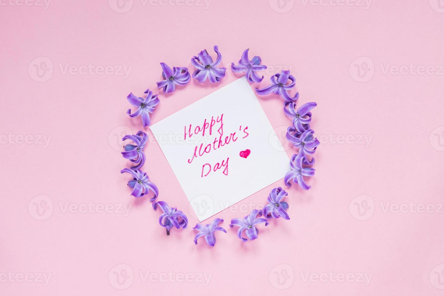 Round frame of pastel purple hyacinth flowers and mothers day greeting on gradient pink background. Floral wreath. Layout for holidays greeting of Mothers day photo