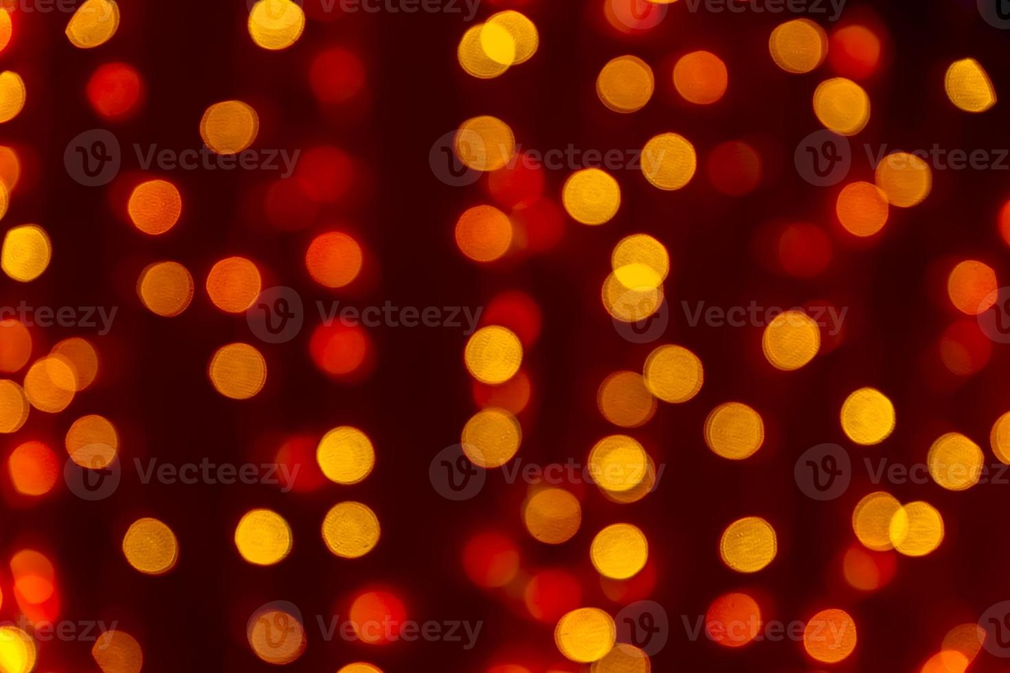 Bokeh abstract texture. Beautiful christmas background in orange colors. Defocused image photo