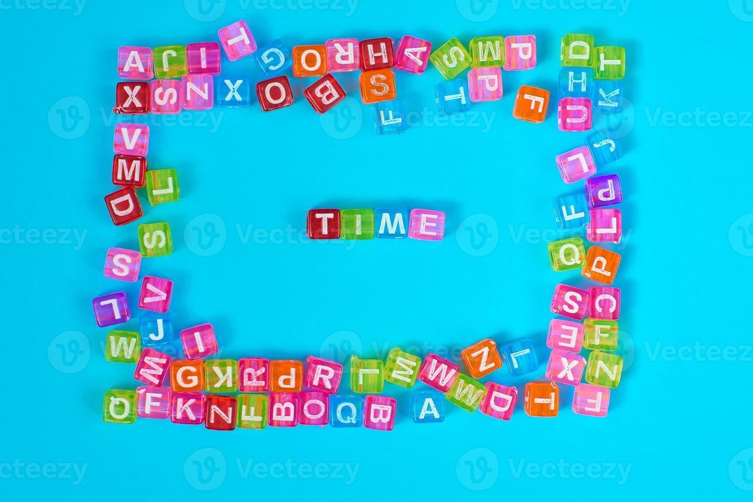 TIME inscription made of colorful cube beads with letters. Festive blue background concept with copy space photo