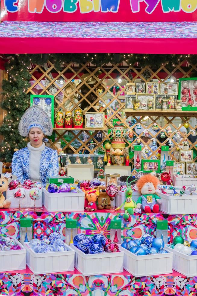 MOSCOW, RUSSIA, 2018 - GUM Main Department Store New Year and Christmas fair. Sellers in national costumes. Presents for tourists photo