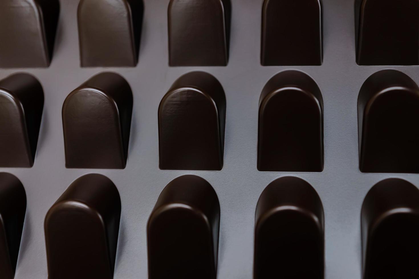 empty box of chocolate shapes. Abstract texture background photo