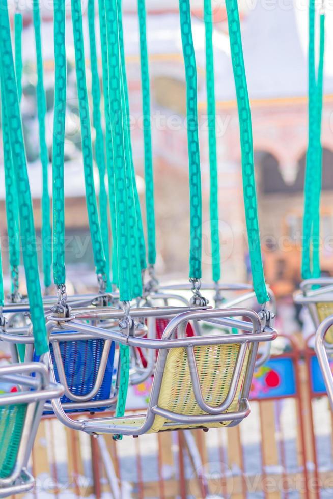 empty seats of childrens carousel in amusement park photo