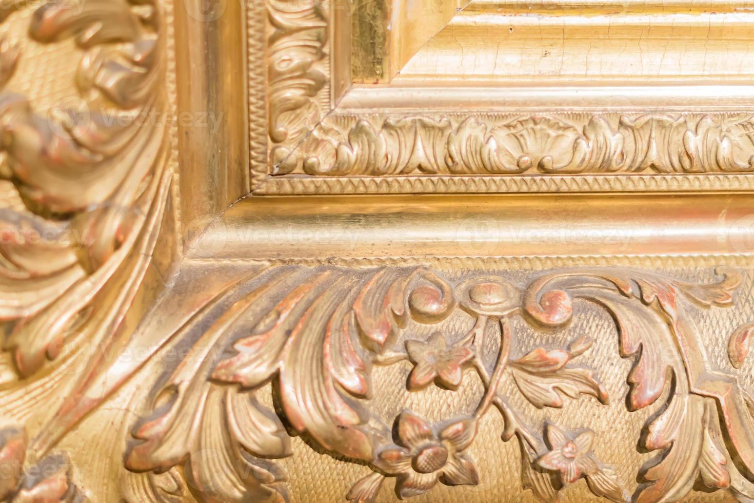 close up of rustic baguette of the painting. gold carved flowers and leaves photo