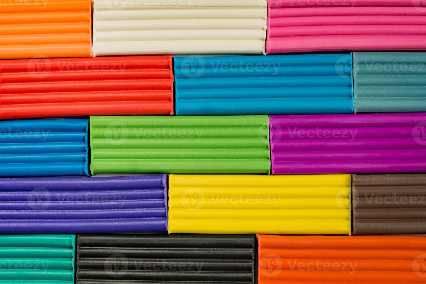 Rainbow colors of modeling clay. Multicolored plasticine bars background. photo
