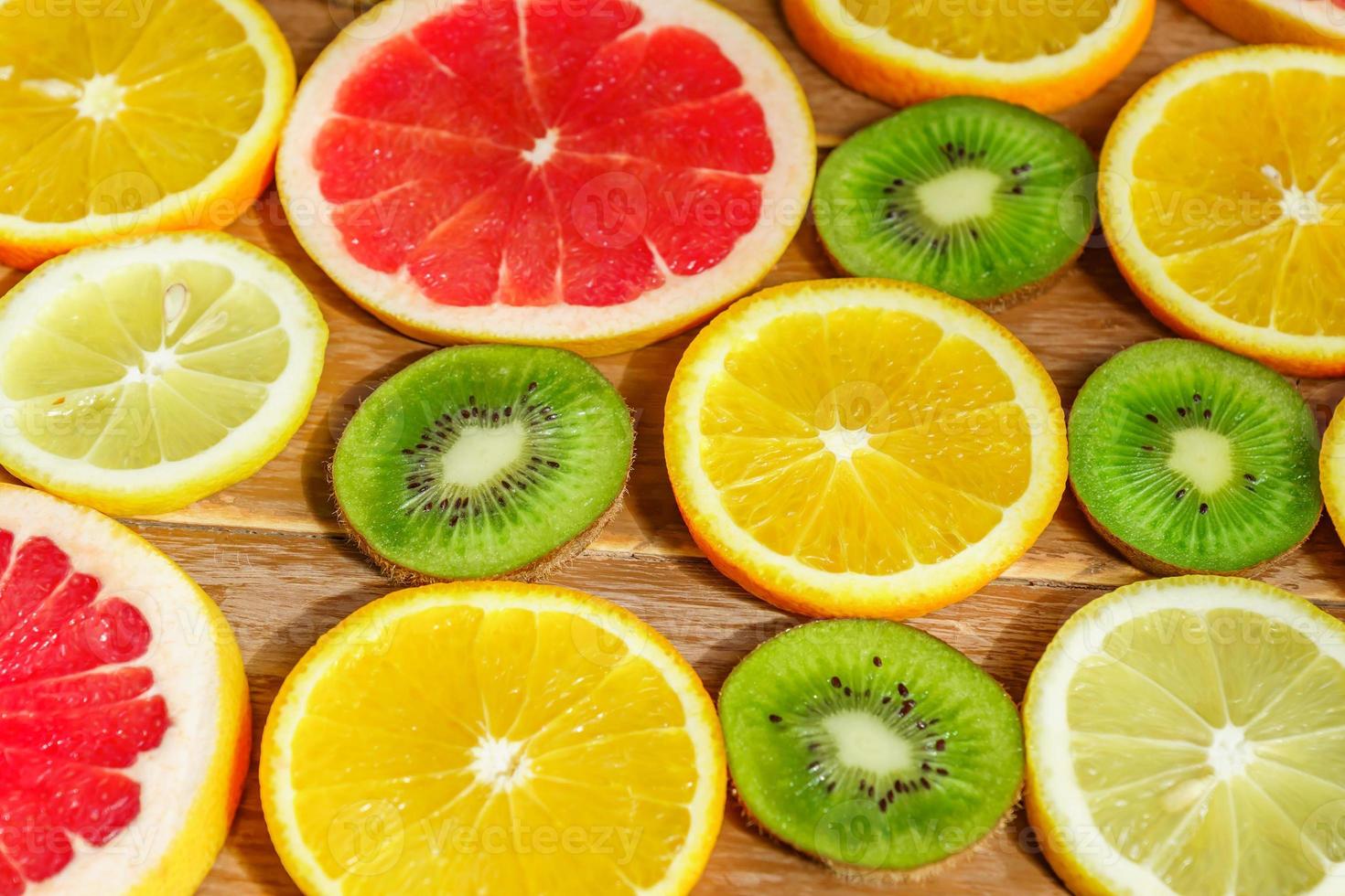 frame with slice of oranges, lemons, kiwi, grapefruit pattern isolated on white background. photo