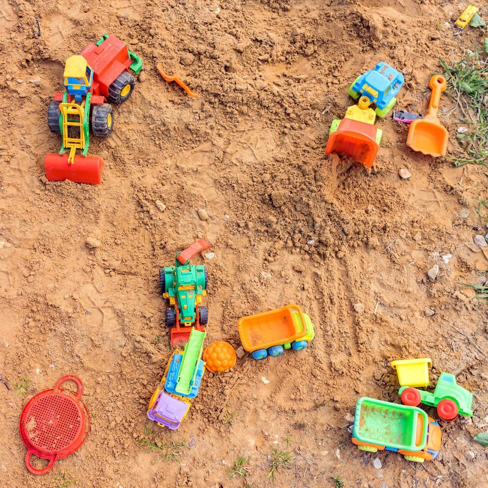 Playground with different toy transportation. Trucks and excavators for playing in the sand photo