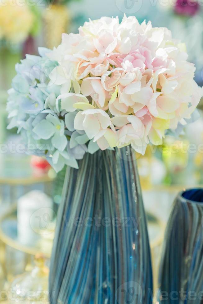 close up of blue glossy vase with hydrangea flovers. Interior decoration. photo