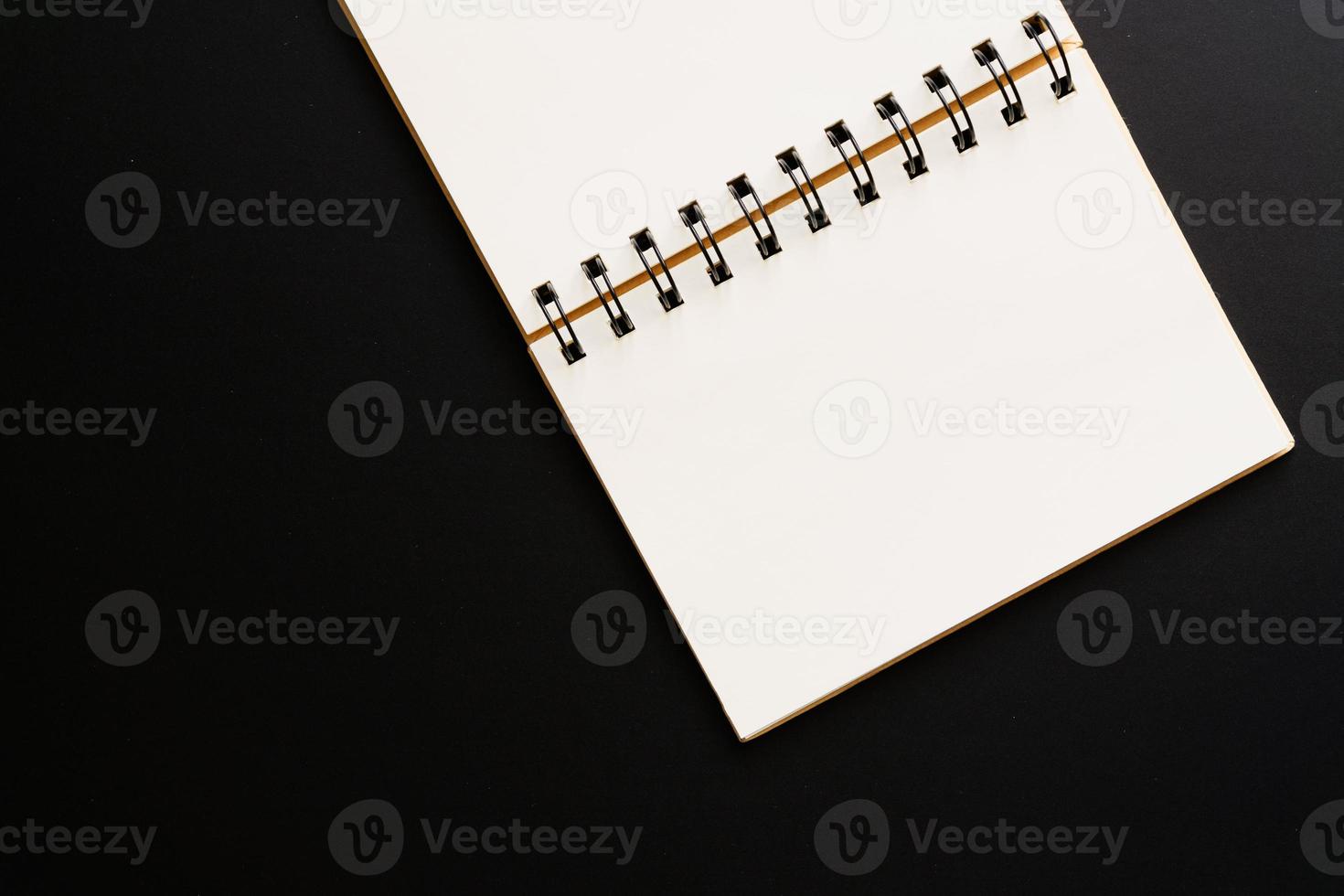 Design concept - Top view of empty kraft notebook on black background. mock up. photo