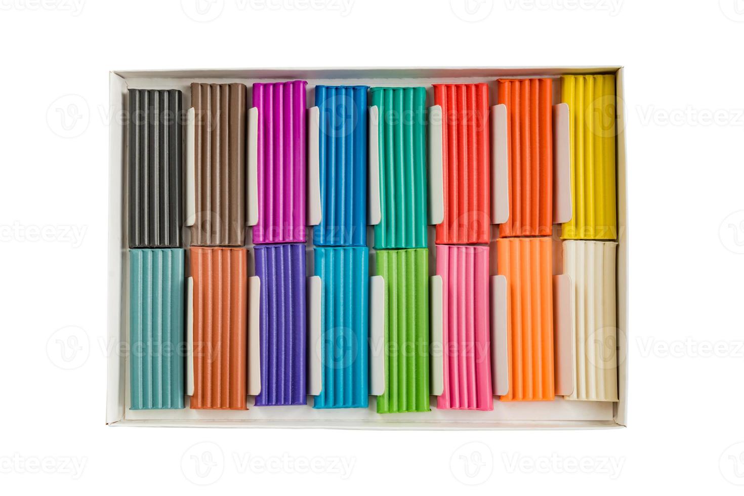 Modeling clay. Multicolored plasticine bars in a box isolated on white background. photo