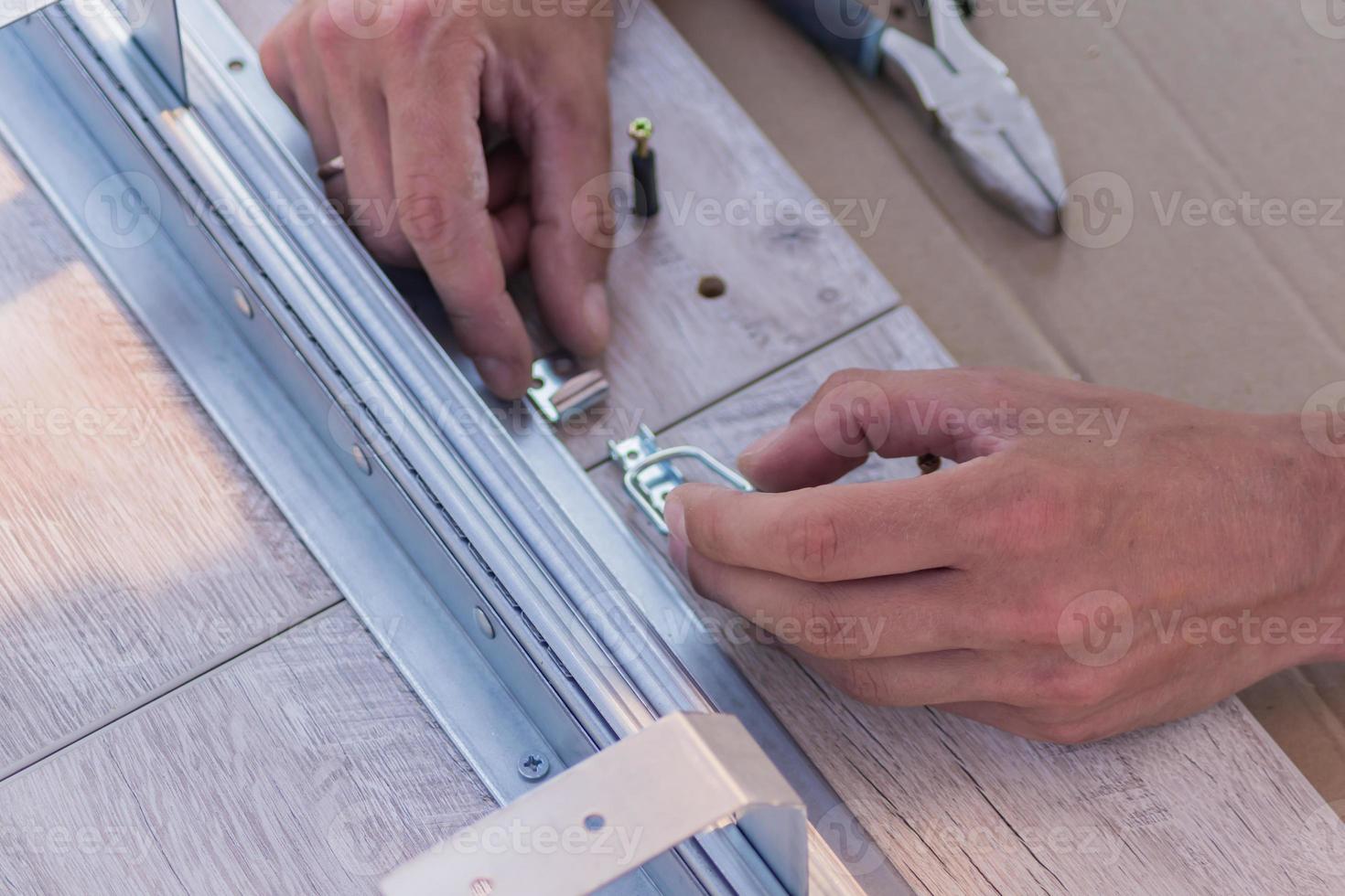furniture assembling - Carpentry joins up the table photo