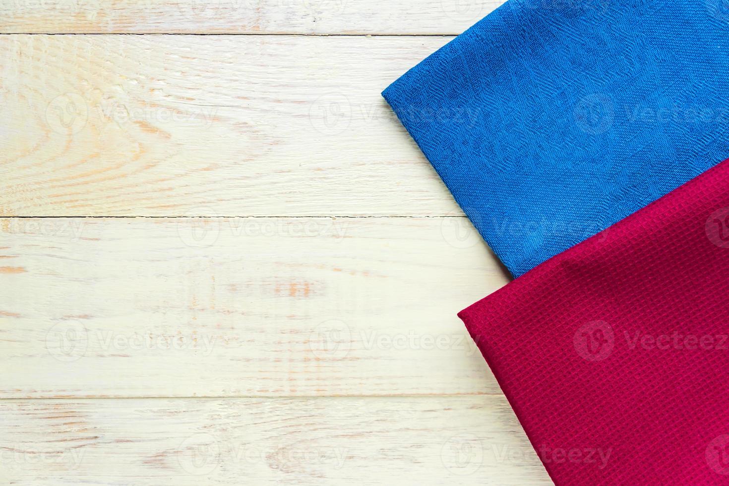 Top view of cloth napkins of blue and burgundy colors on rustic white background. Copy space for text photo