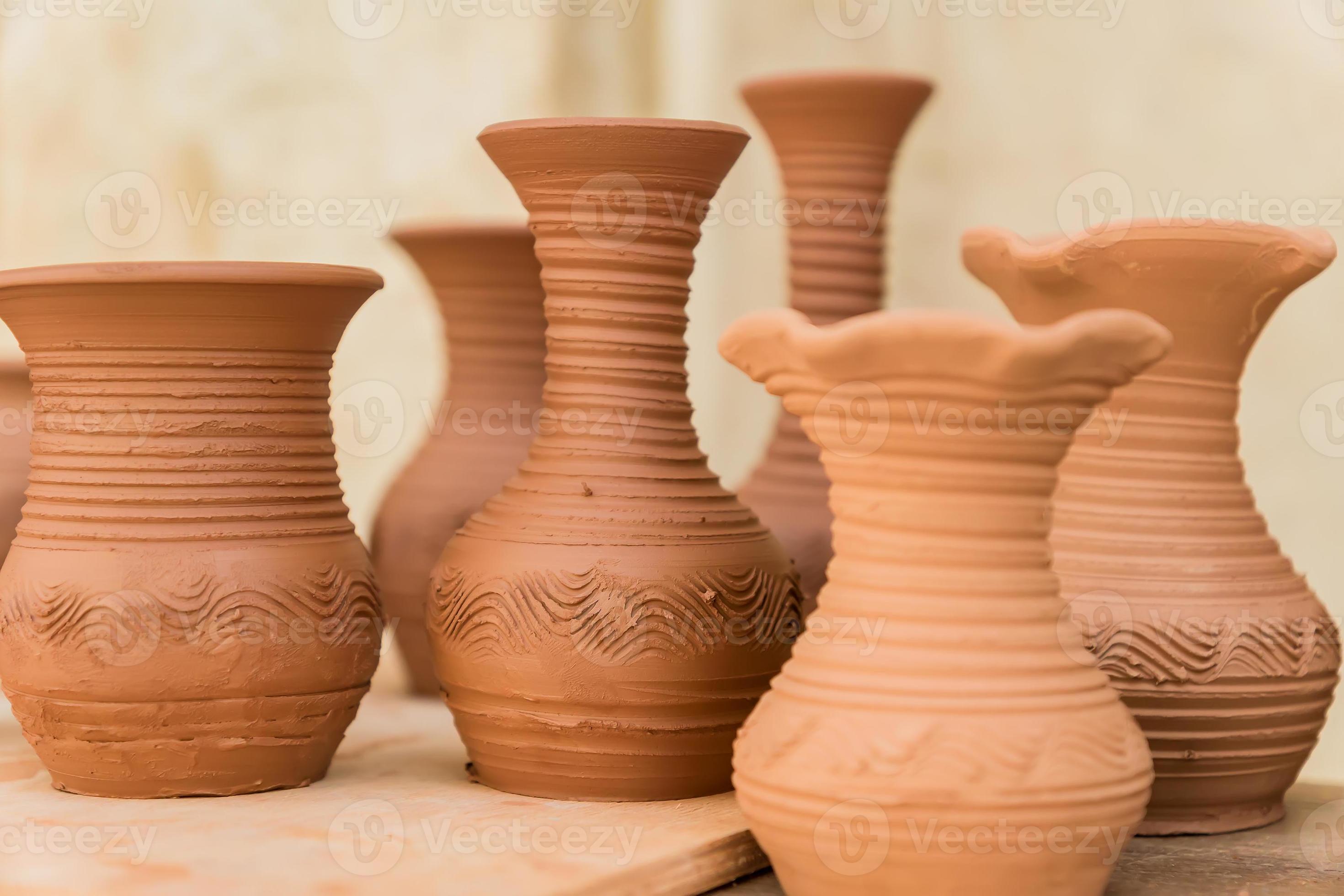different clay pots on a wooden table 10609964 Stock Photo at Vecteezy
