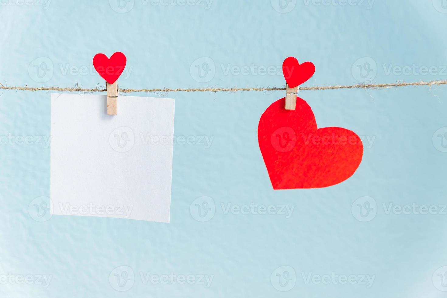 Blank cards on pins with red hearts. Mockup for text and blue background for Valentines Day greetings photo