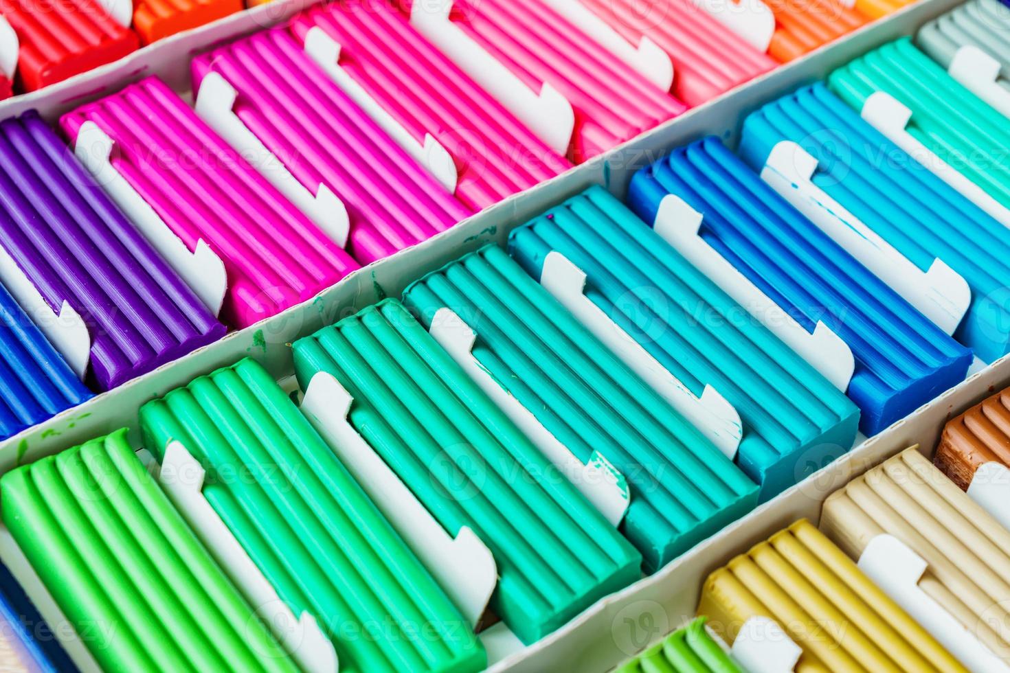 Rainbow colors of modeling clay. Multicolored plasticine bars ina box, background texture photo