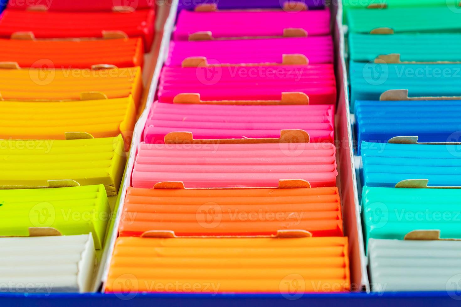 Rainbow colors of modeling clay. Multicolored plasticine bars ina box, background texture photo