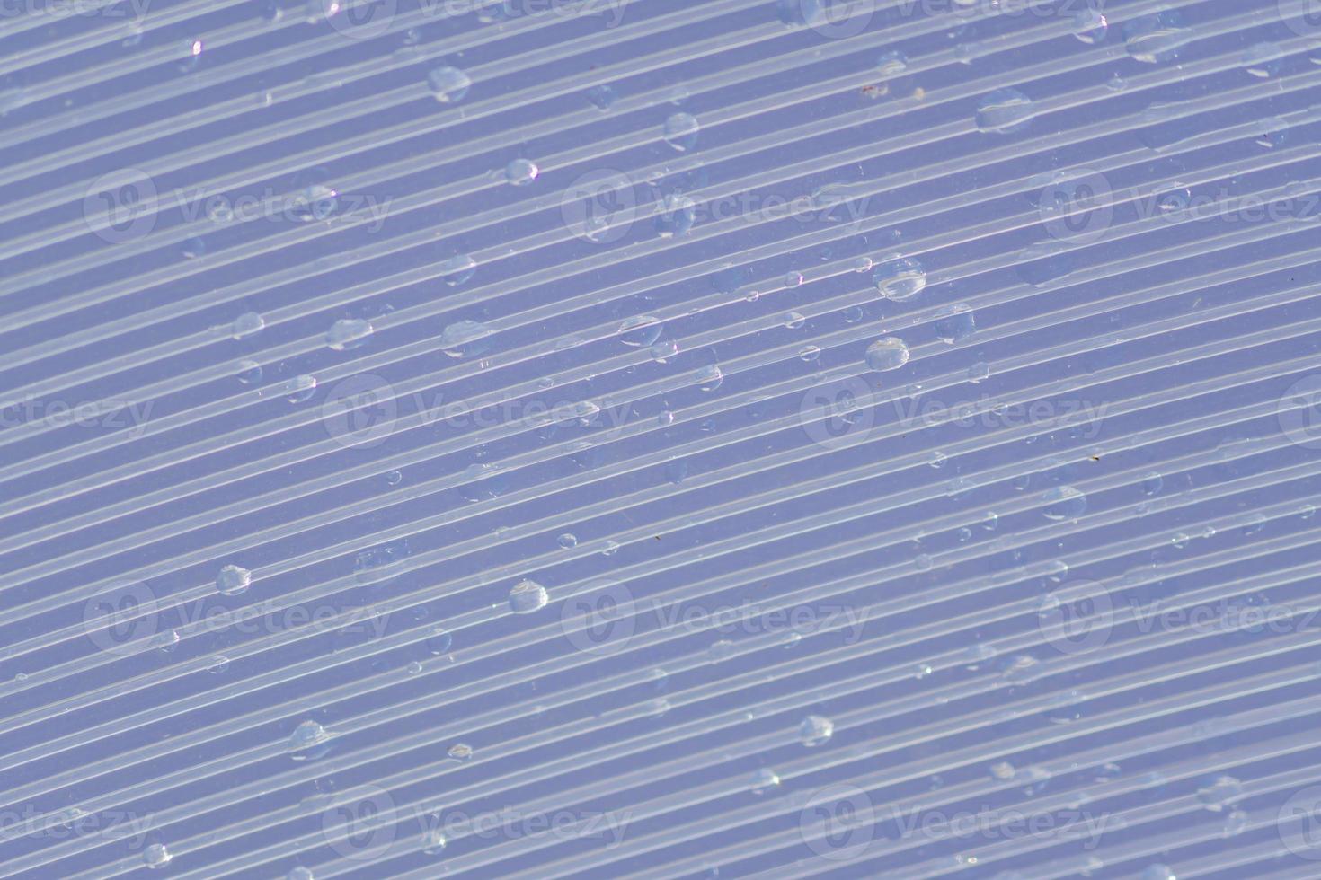 Transparent Polycarbonate plastic sheet with drops, background texture with space for text photo
