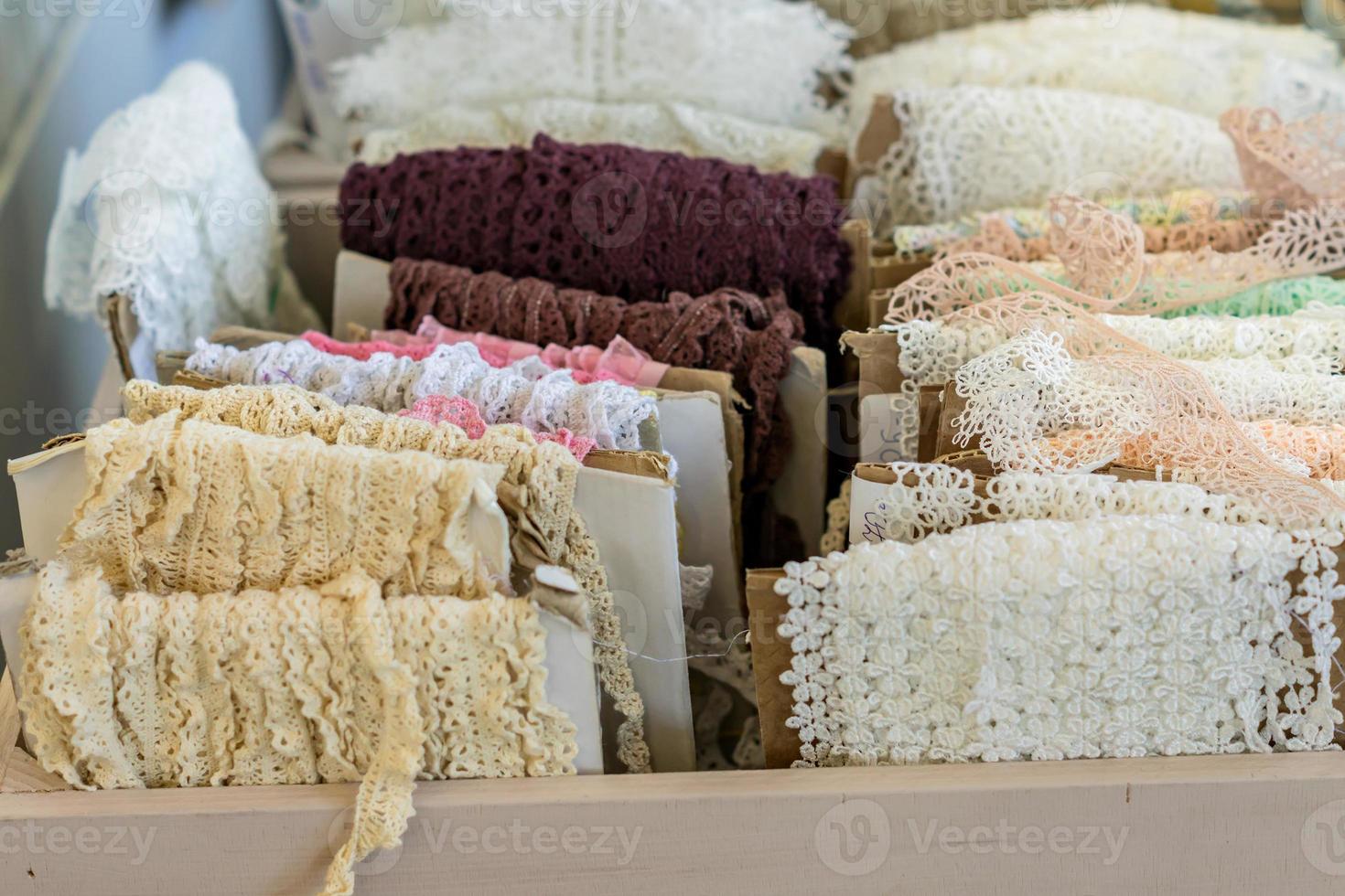 Variety of colorful lace displayed for sale at market photo