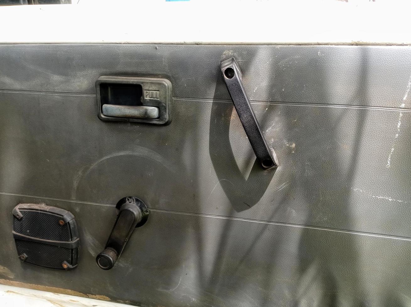 interior door panels in an old car in gray color and equipped with original manual handles and window adjusters photo