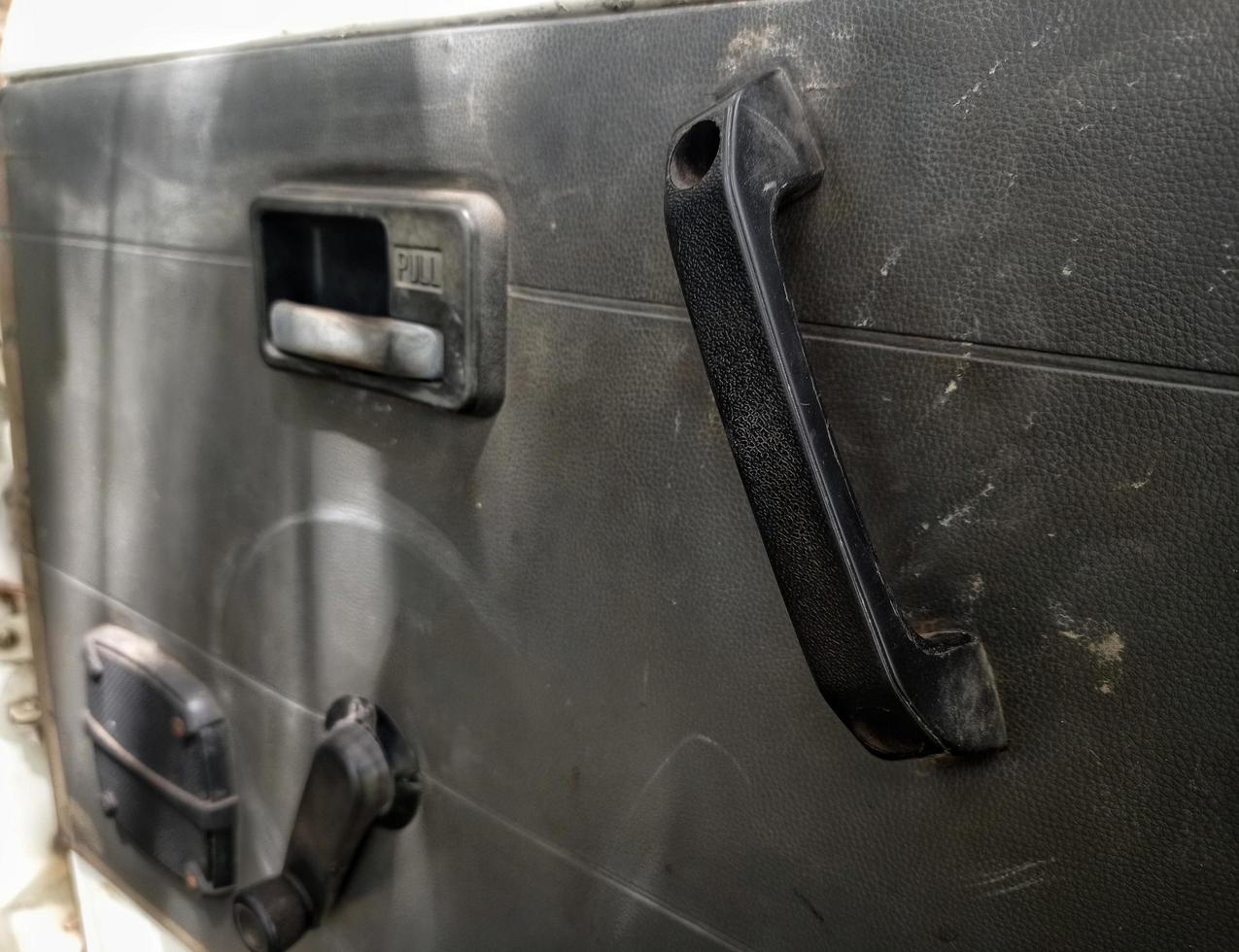 interior door panels in an old car in gray color and equipped with original manual handles and window adjusters photo