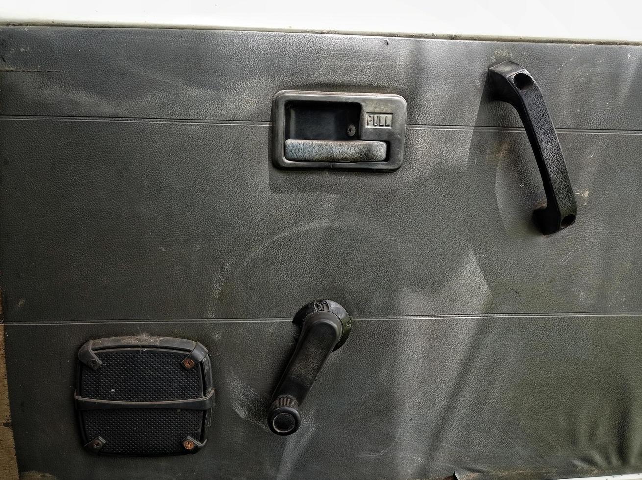 interior door panels in an old car in gray color and equipped with original manual handles and window adjusters photo