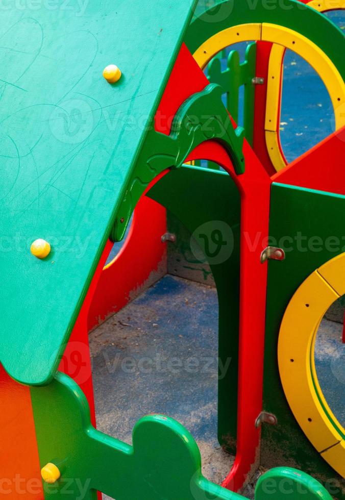An element of a children's swing. rope. An outdoor colorful playground next to the house. A summer day. Children's playground with rubber floor covering. photo