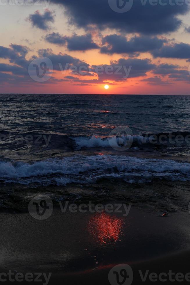 The sun sets below the horizon on the Mediterranean Sea in northern Israel. photo