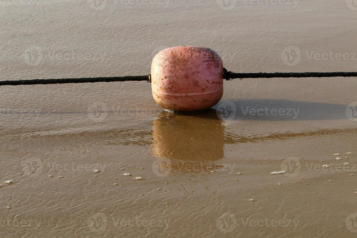 A rope with floats to secure a safe swimming area on the beach. photo