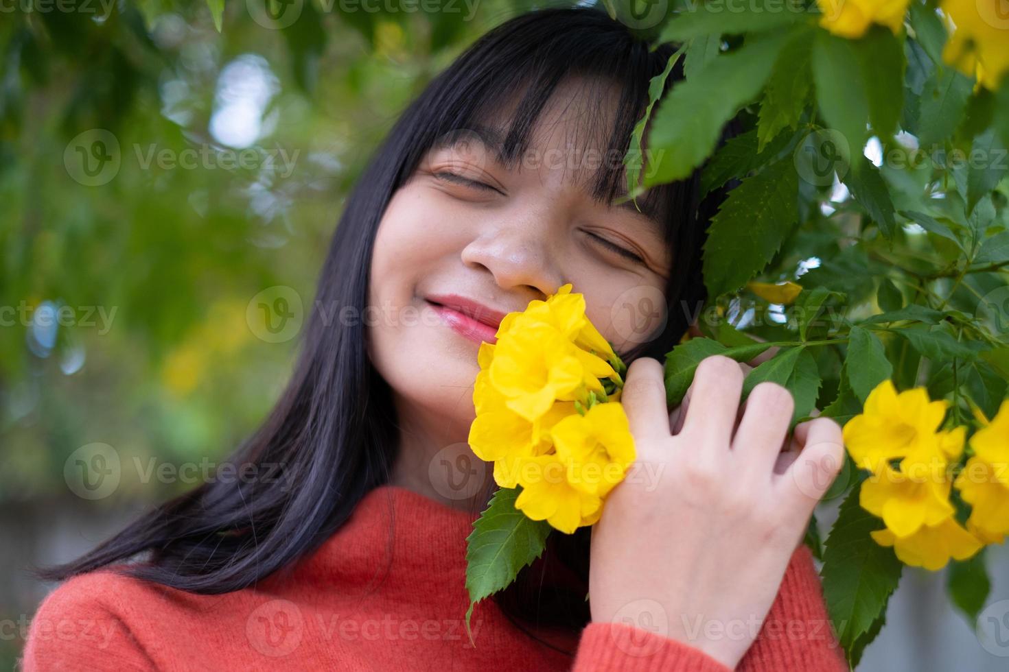 Portrait young girl with yellow flowers, Asian girl. photo