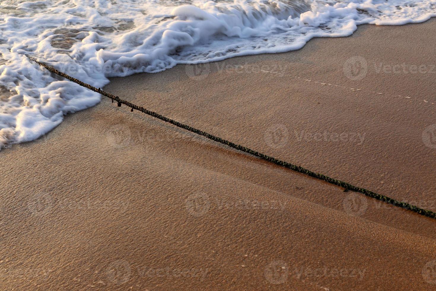 A rope with floats to secure a safe swimming area on the beach. photo