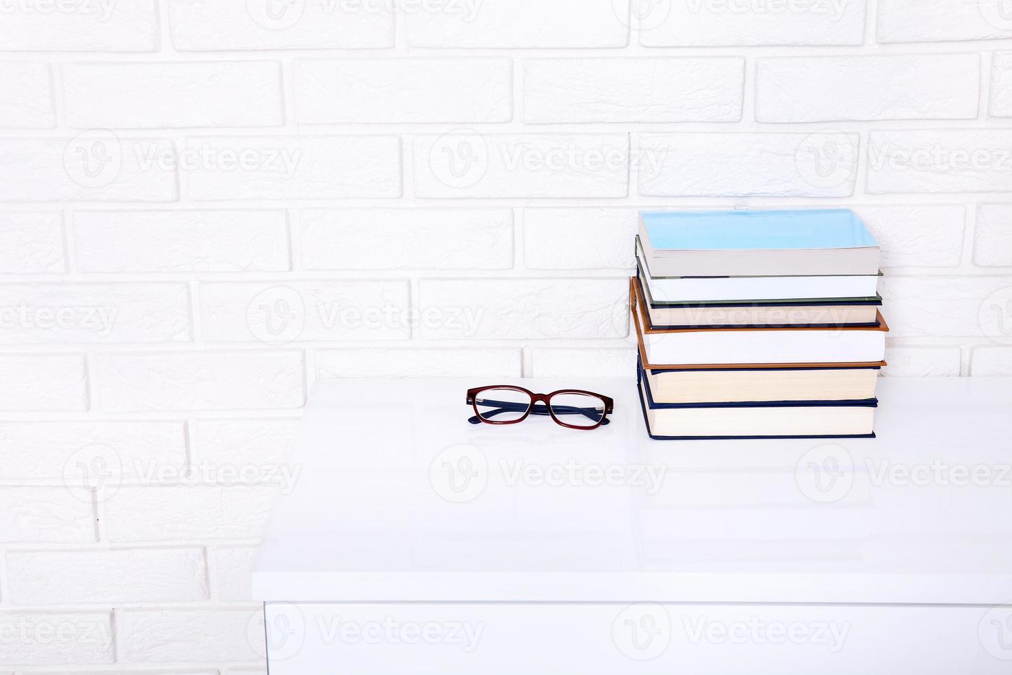 Books and glasses on the table. Top view and selective focus photo