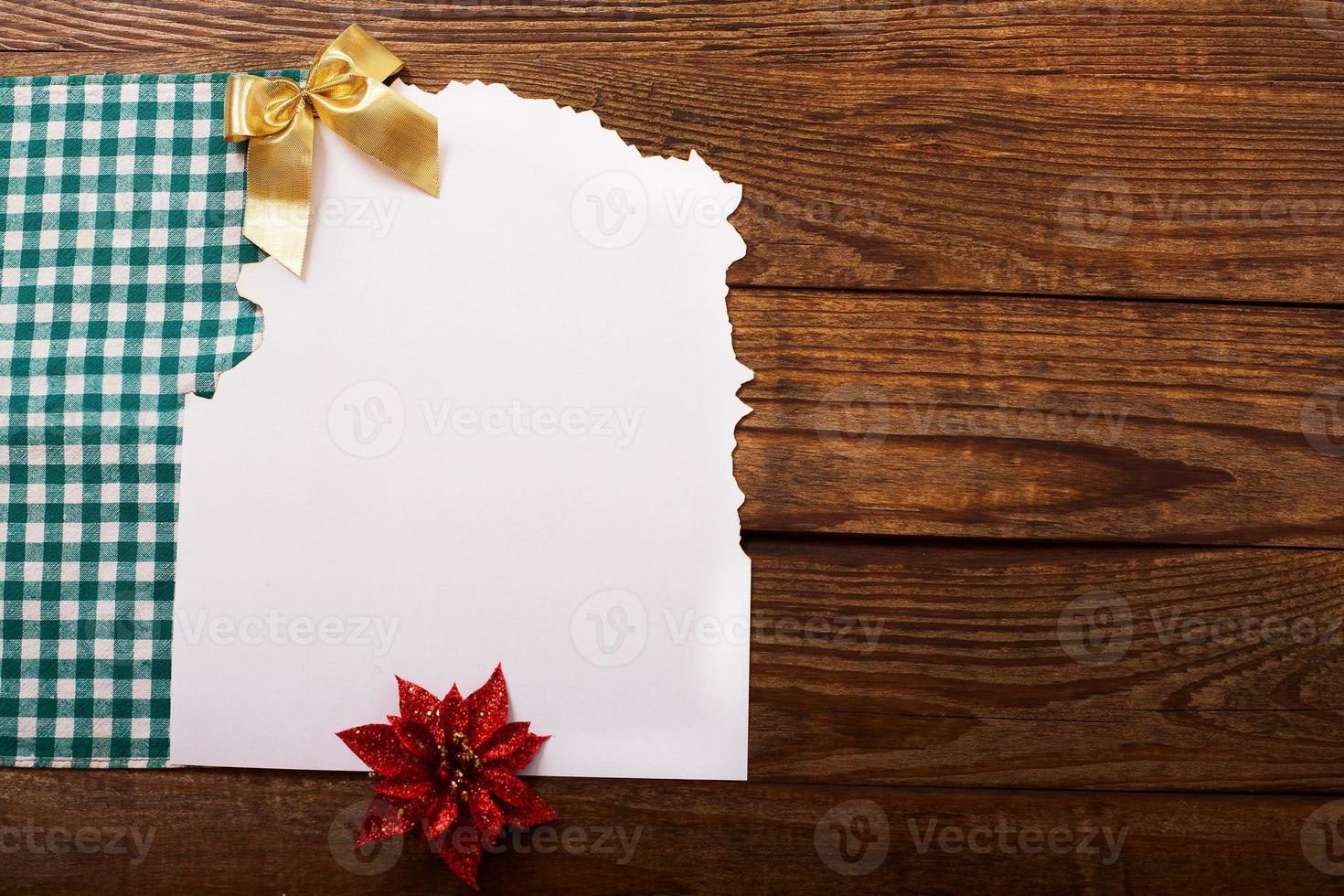 Christmas card and New Year accessories on brown wooden table. Top view. Copy space and place for text. photo