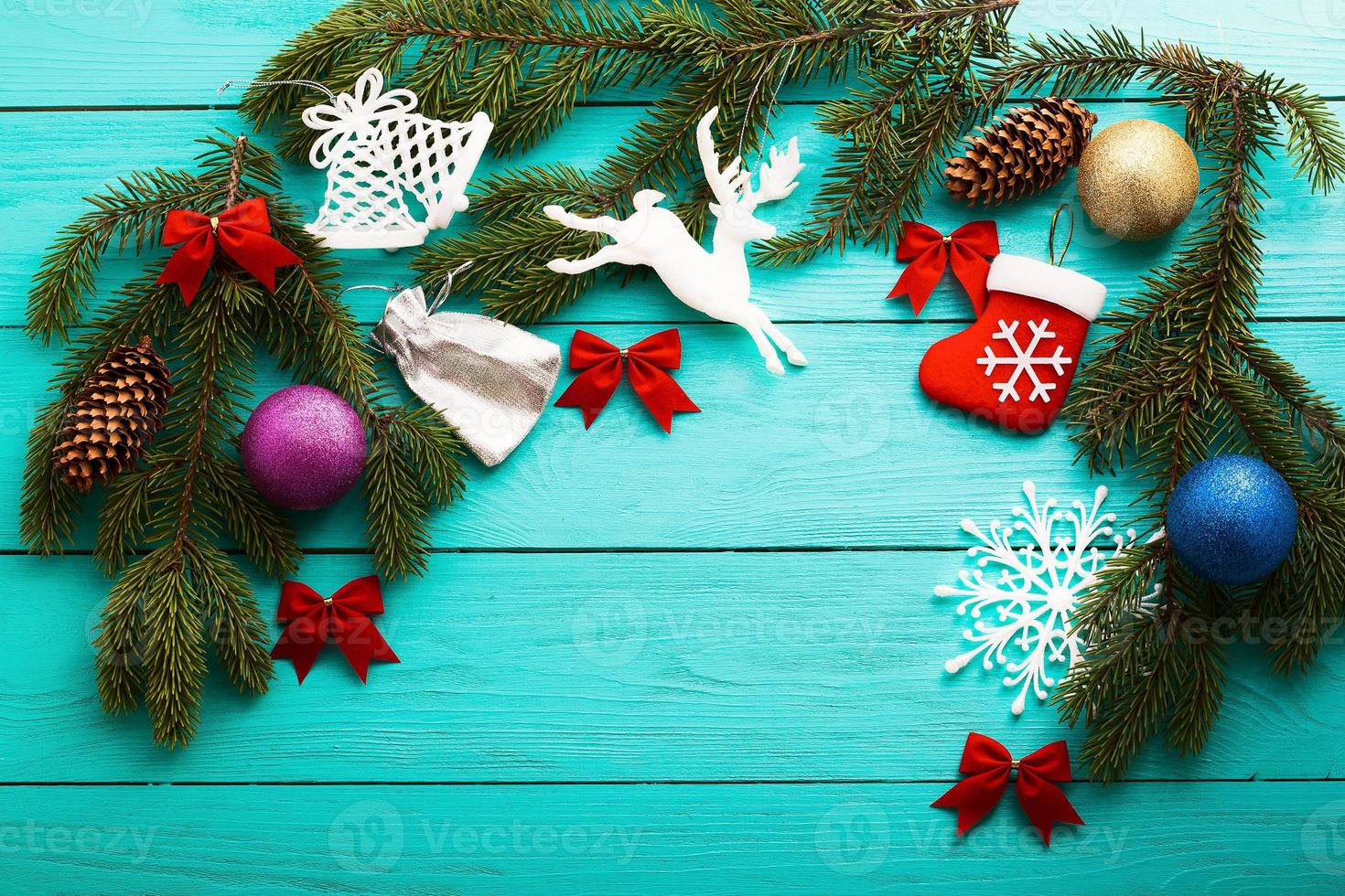 Christmas card with frame of winter accessories on blue wooden background.Top view and selective focus photo