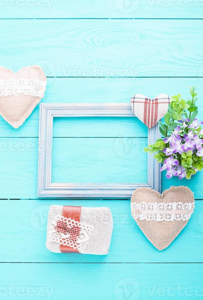 Frame for card and accessories on blue wooden background with copy space.Top view photo