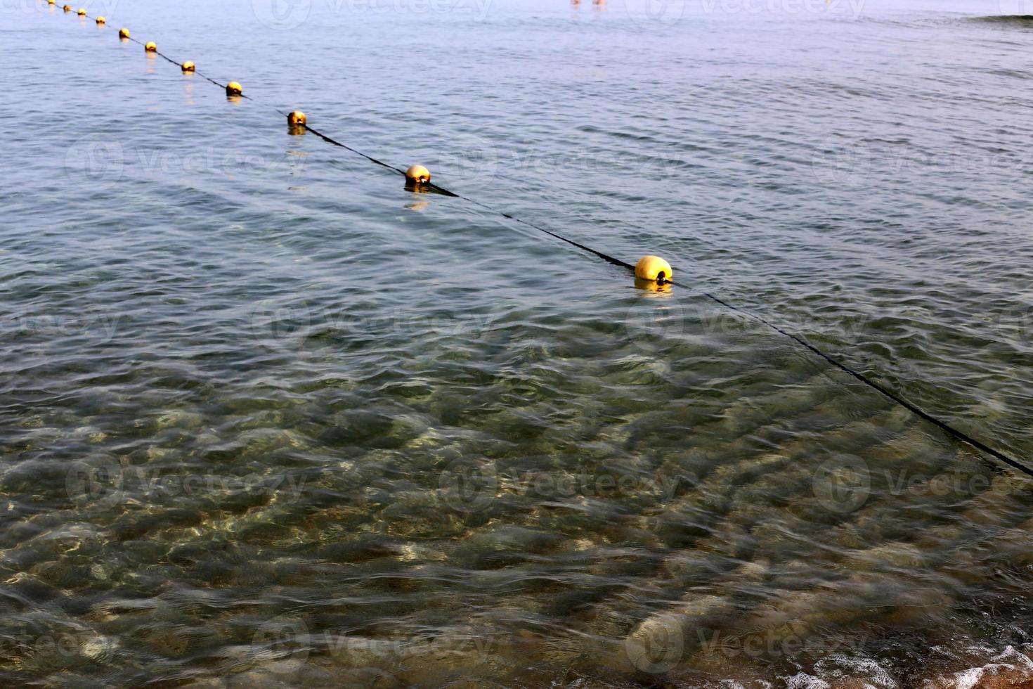 A rope with floats to secure a safe swimming area on the beach. photo