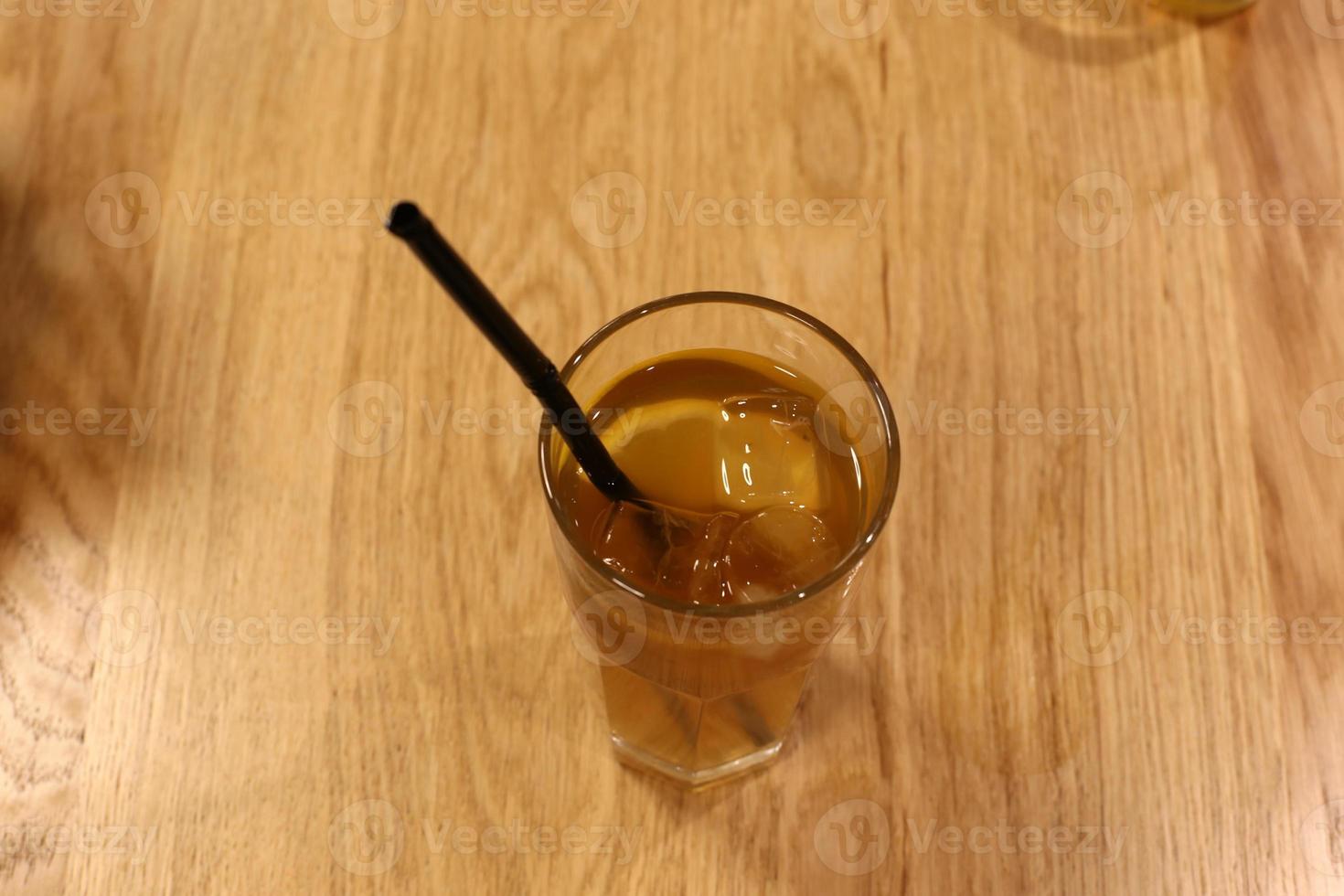On the table in a glass of soft drinks. photo