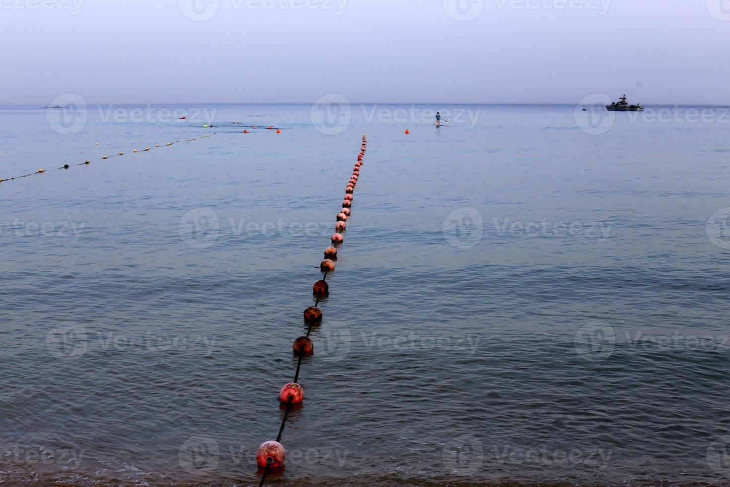 A rope with floats to secure a safe swimming area on the beach. photo