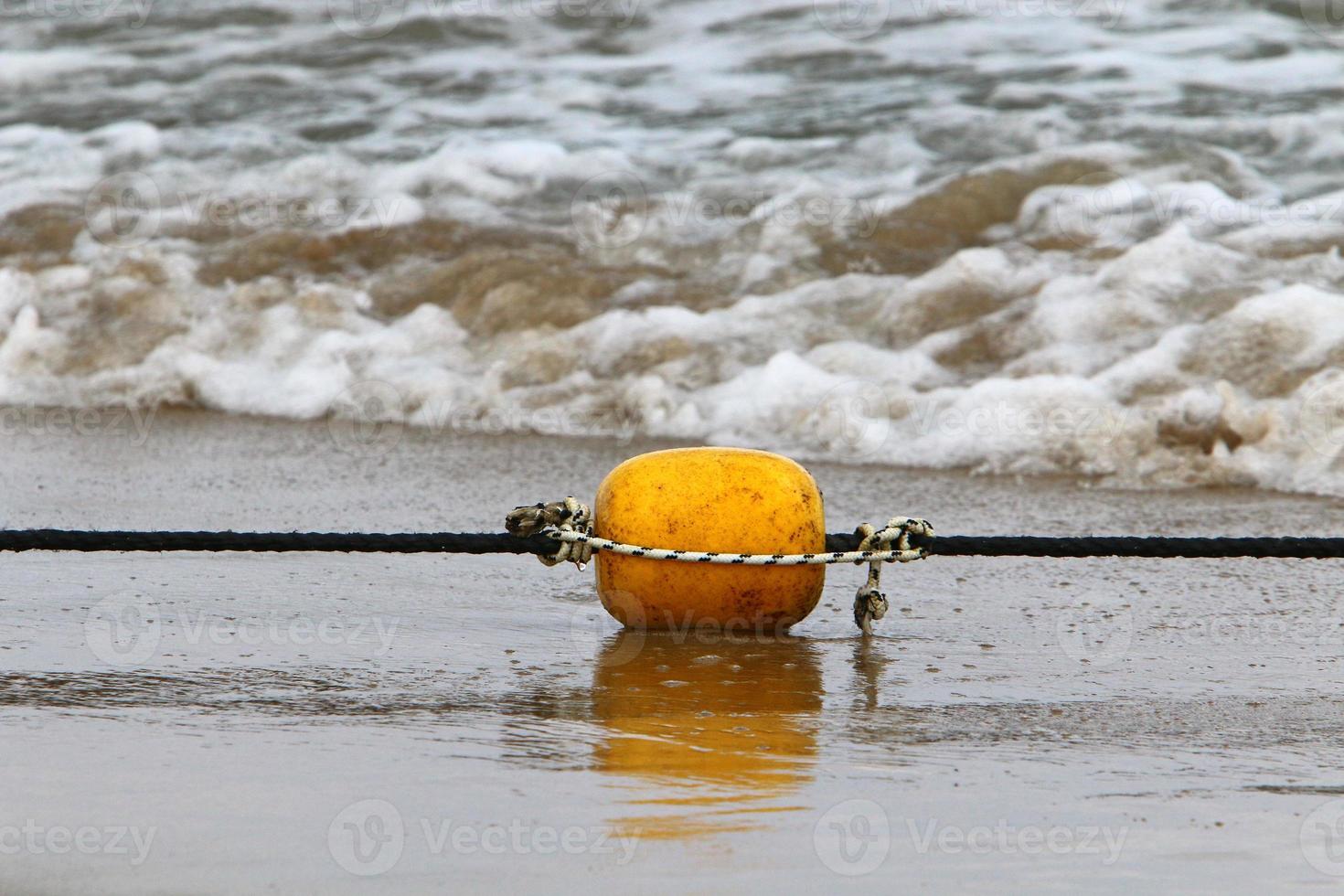 A rope with floats to secure a safe swimming area on the beach. photo