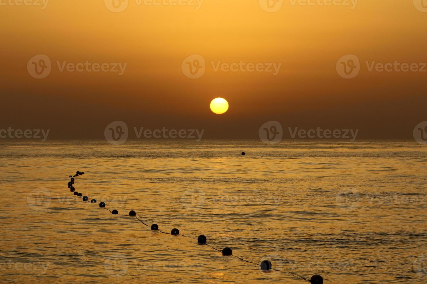 The sun sets below the horizon on the Mediterranean Sea in northern Israel. photo
