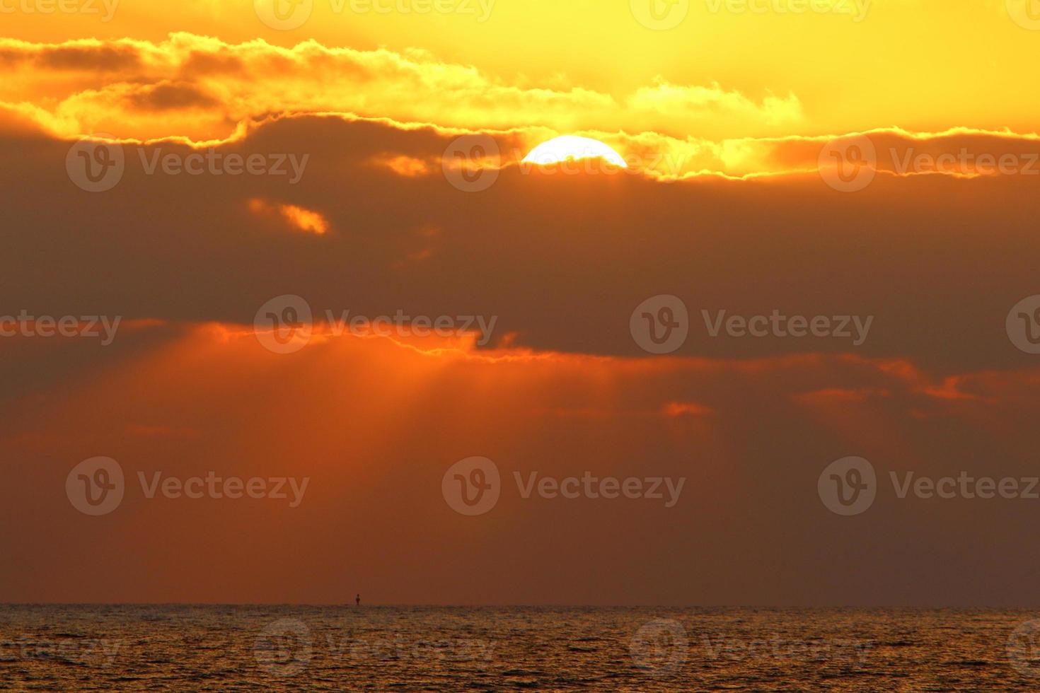 The sun sets below the horizon on the Mediterranean Sea in northern Israel. photo