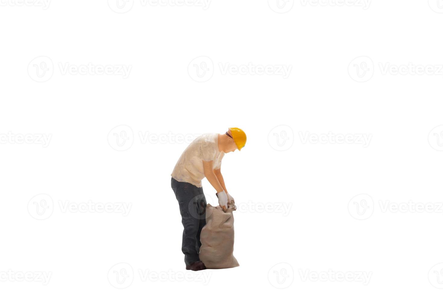 Miniature  worker isolated on white background with clipping path photo
