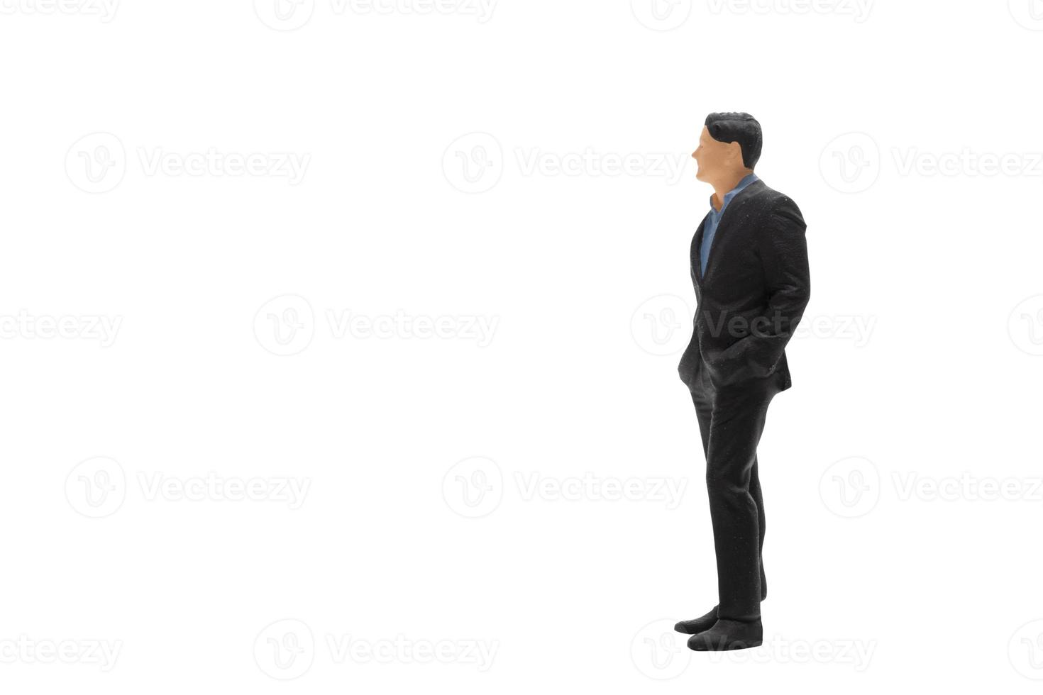 Miniature people businessman wearing black suit with clipping path photo