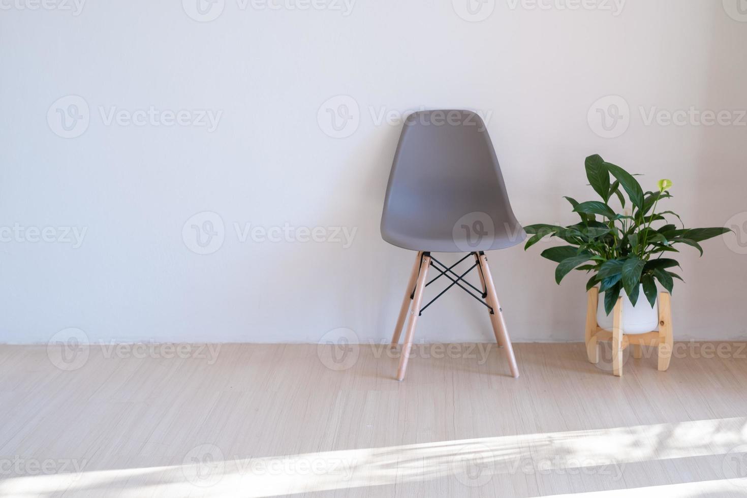 Gray chairs and green plants on the wood floor in a minimal room. photo