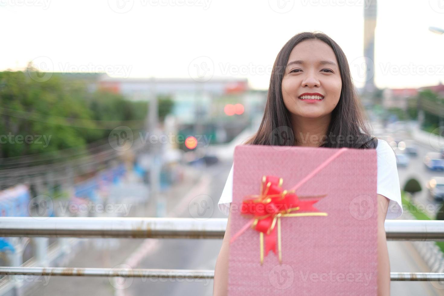 Happy young girl with gift box. photo