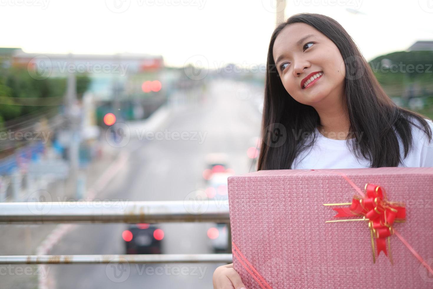 Happy young girl with gift box. photo