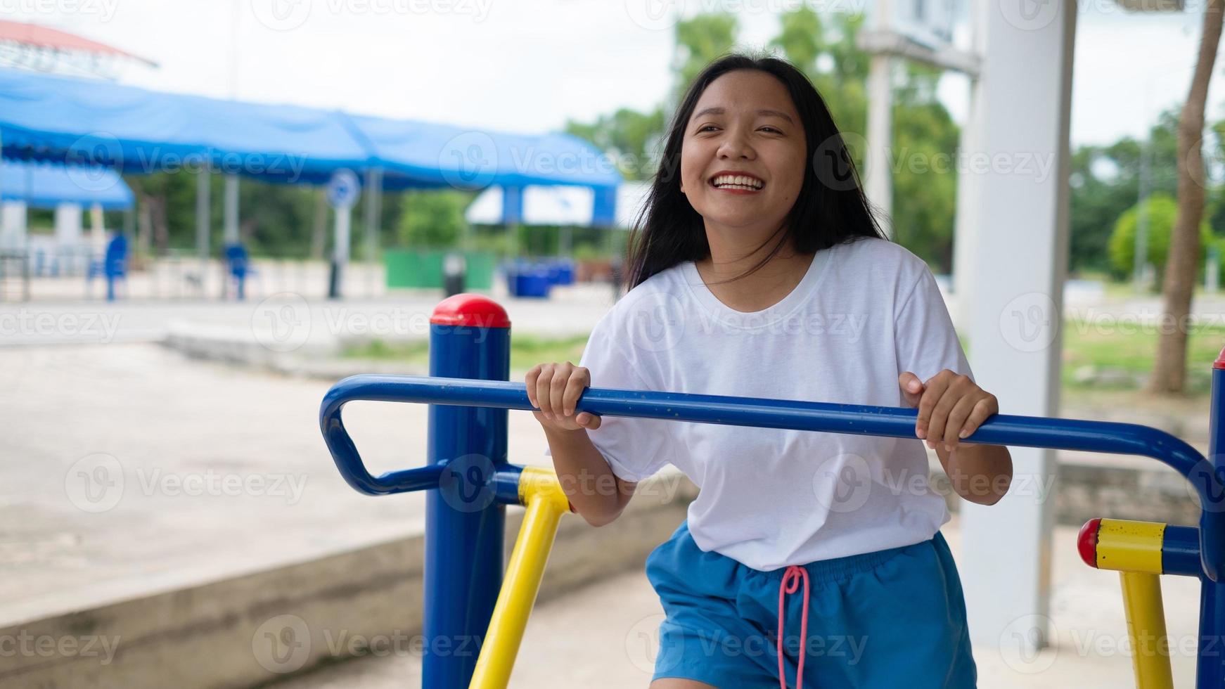 Young girl doing exercise with colorful equipment exercise. photo