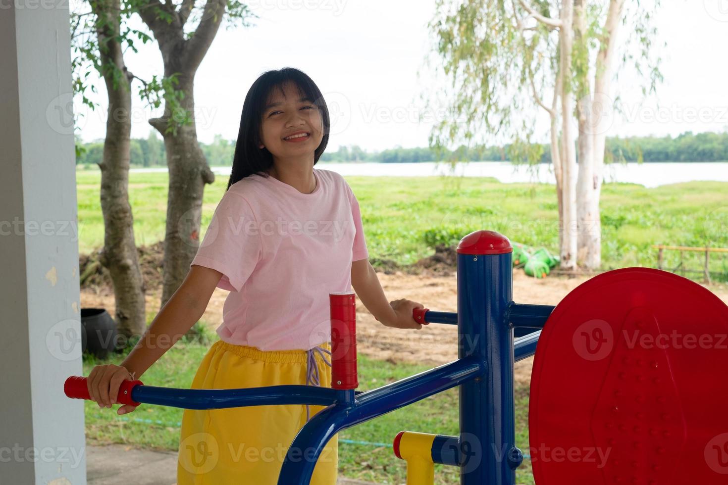 Young girl doing exercise with colorful equipment exercise. photo